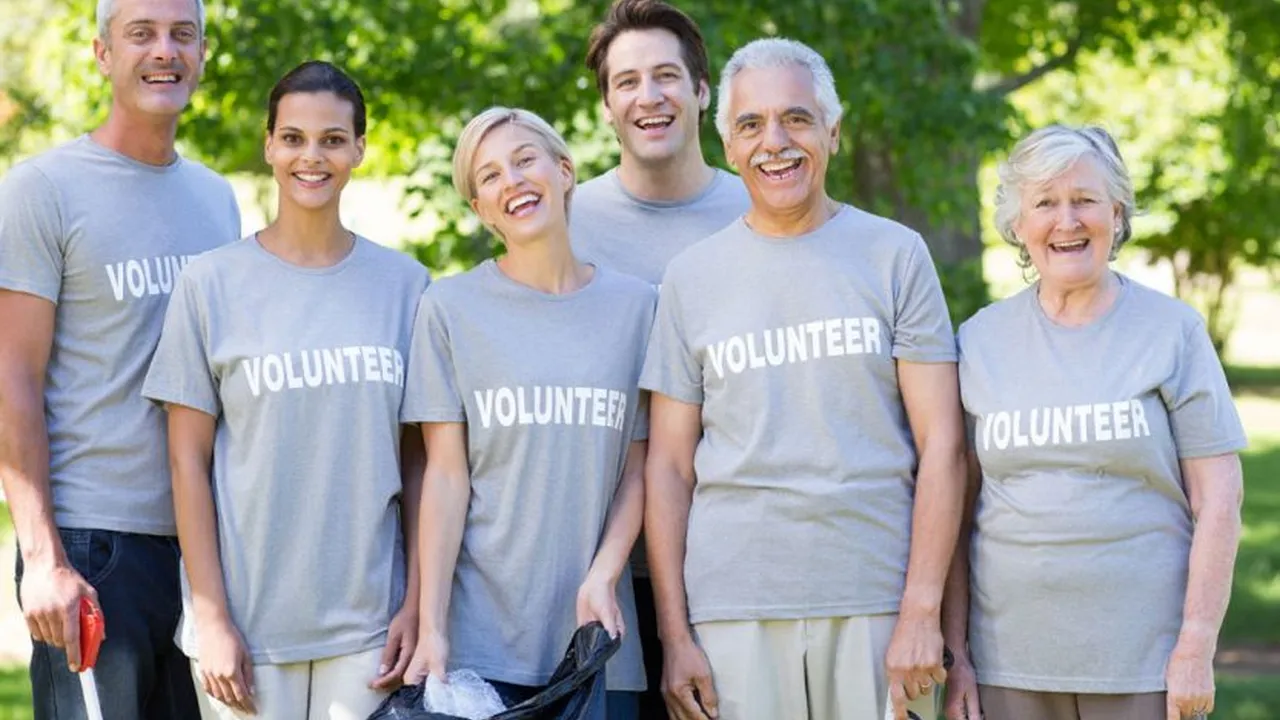 Close up on a plate of mashed potatoes, topped with baked pork chops with cream of mushroom soup, and a side of green beans.
