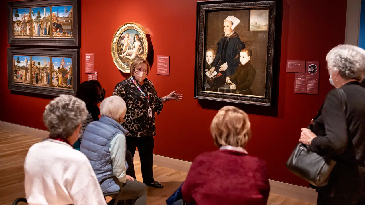 Close up on a plate of mashed potatoes, topped with baked pork chops with cream of mushroom soup, and a side of green beans.