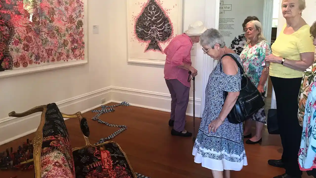Close up on a plate of mashed potatoes, topped with baked pork chops with cream of mushroom soup, and a side of green beans.