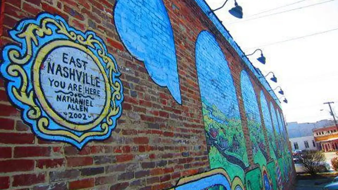 Close up on a plate of mashed potatoes, topped with baked pork chops with cream of mushroom soup, and a side of green beans.