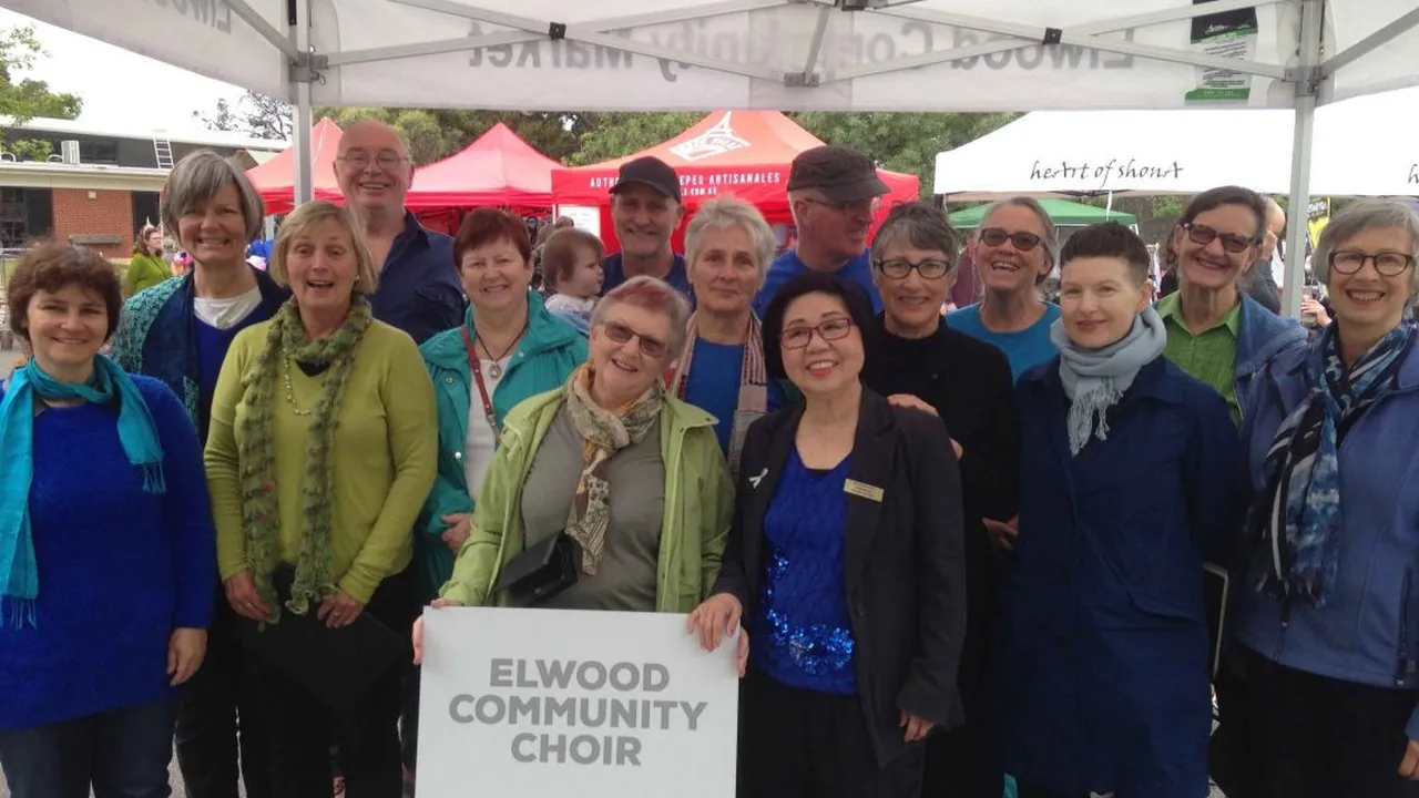 Close up on a plate of mashed potatoes, topped with baked pork chops with cream of mushroom soup, and a side of green beans.