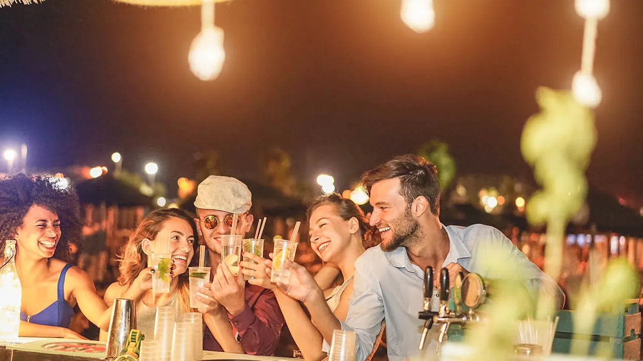 Close up on a plate of mashed potatoes, topped with baked pork chops with cream of mushroom soup, and a side of green beans.