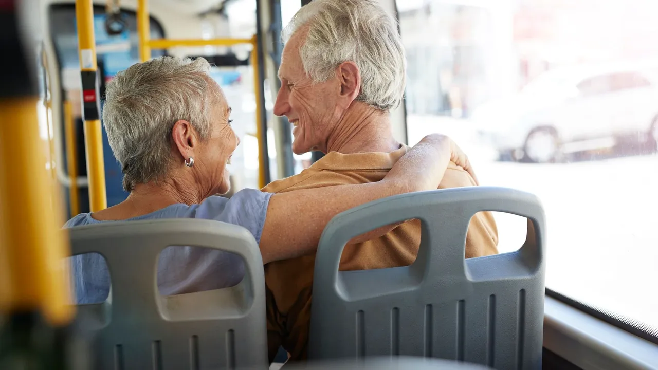 blue bowl of black bean beef tortilla soup on a board with cilantro and shredded cheese in background