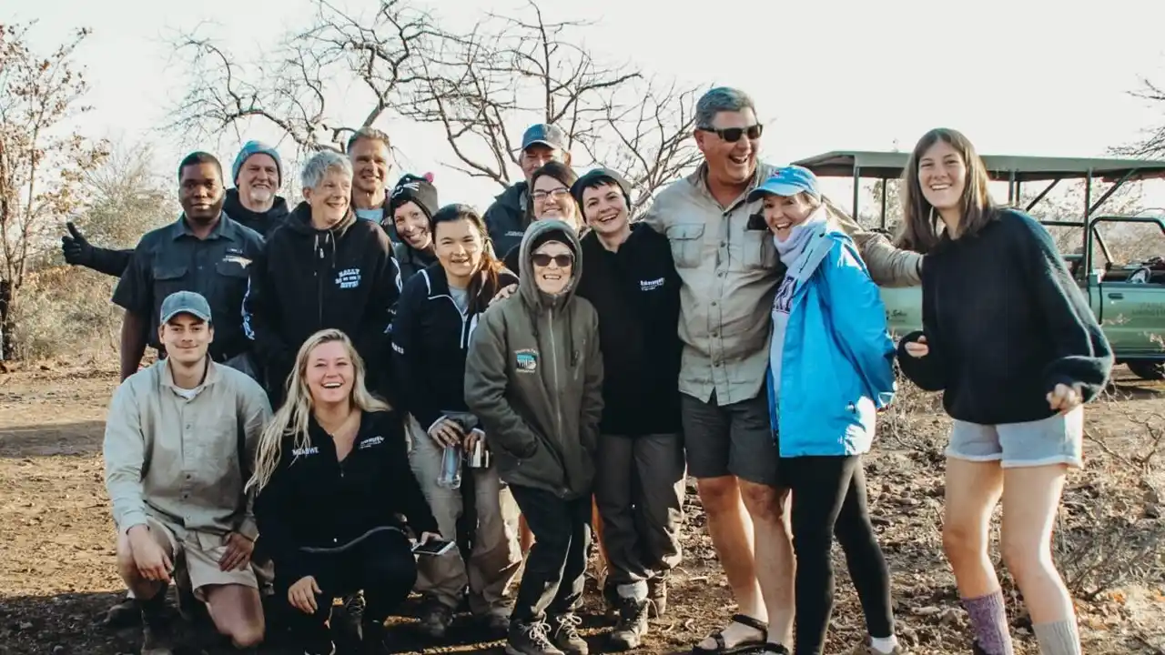 Close up on a plate of mashed potatoes, topped with baked pork chops with cream of mushroom soup, and a side of green beans.
